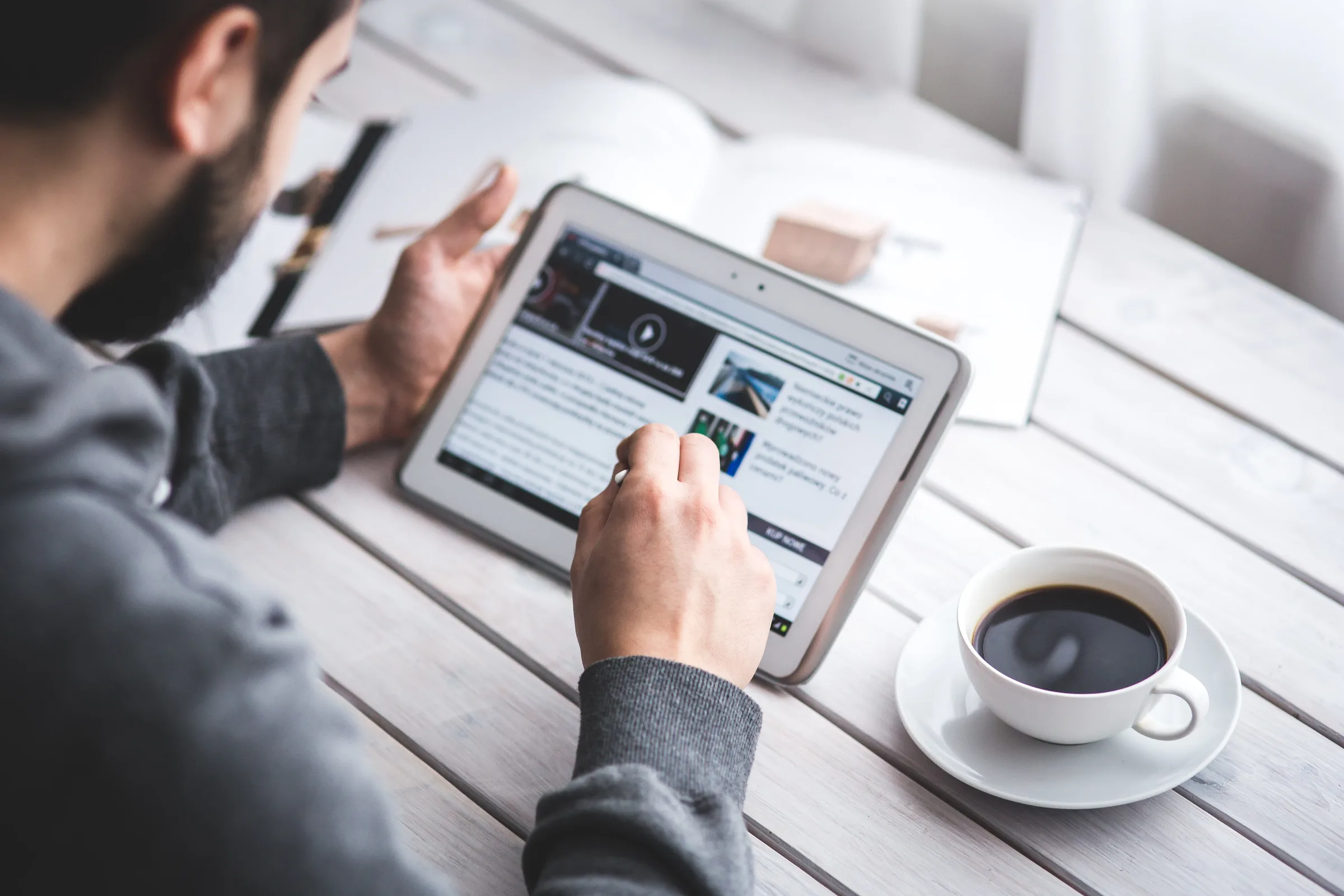 Person reading travel and immigration updates on a tablet